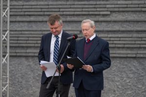 Prelegent przemawia przed Ścianą Pamięci Muzeum Ulmów.
